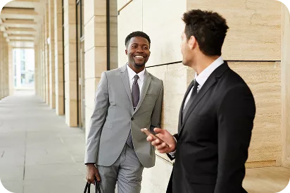 KWPMC Midwest property management professionals engaging in client relations and business development outside a Chicago residential building.
